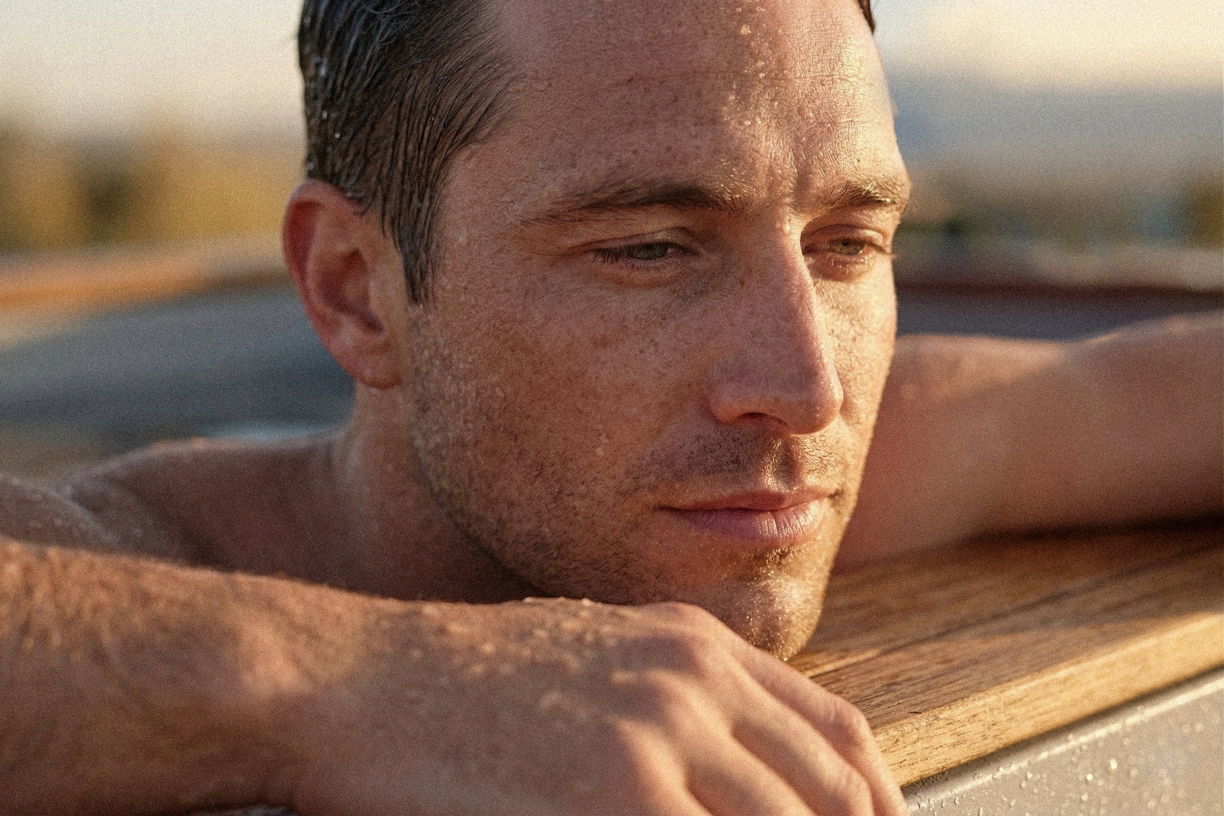 Man resting on the wooden edge of a Temperd cold plunge